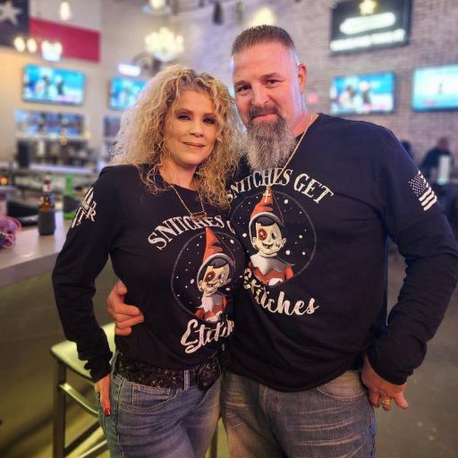 Beautiful couple representing their new long sleeve Snitches Get Stiches t-shirts.
