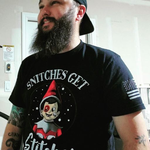 Verified Warrior representing his new Snitches Get Stiches t-shirt.