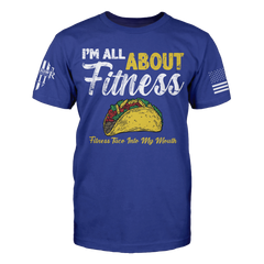 A blue t-shirt with the words 'I'm all about fitness - fitness taco into my mouth" printed on the front.