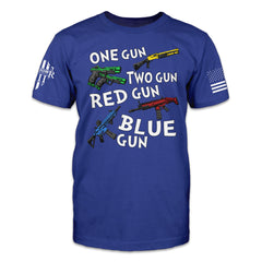 A blue t-shirt with the words "One gun, two gun, red gun blue gun" with colored guns printed on the front.