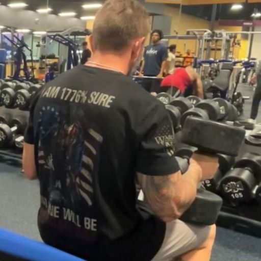 Happy customer working out in his 1776% Sure t-shirt.