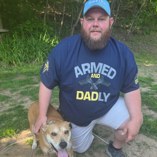 Our awesome customer outside enjoying the day with his dog while wearing Armed and Dadly. 