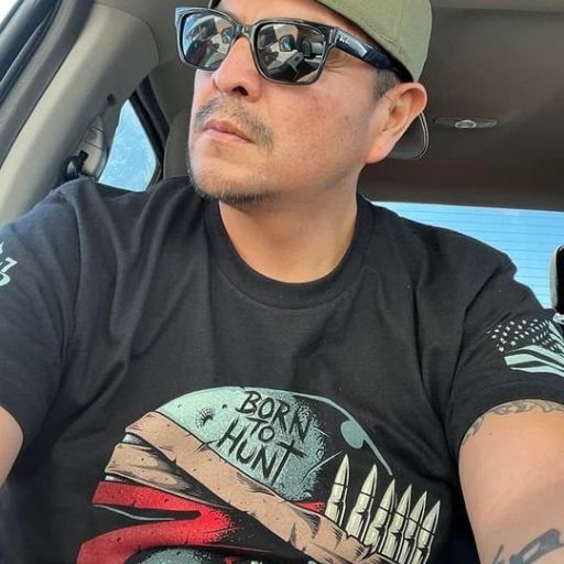 Customer heading out wearing his Born To Hunt t-shirt. A black t-shirt with a helmut and bullets printed on the front of the shirt. Born to hunt.