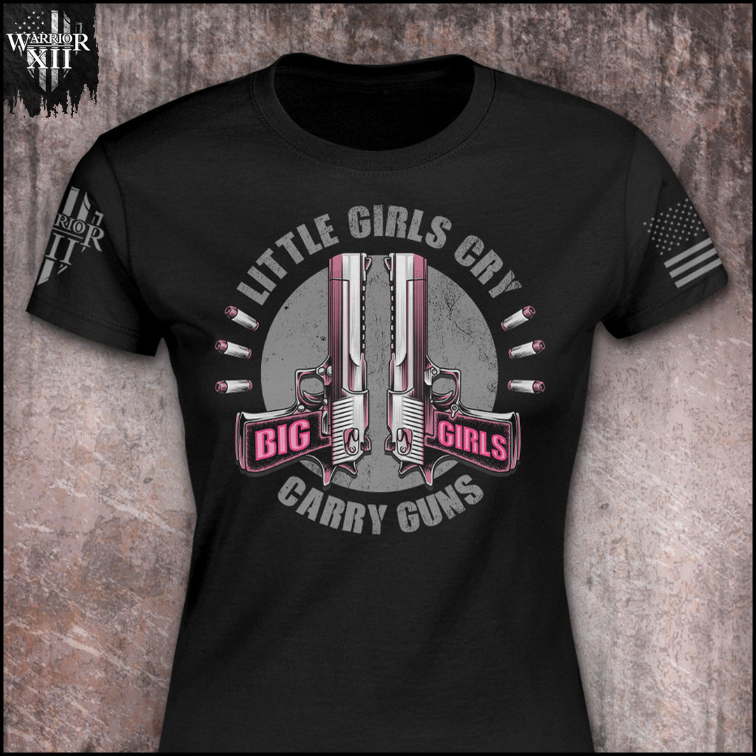 "Big Girls Carry - Women's Relaxed Fit" is printed on a Black t-shirt with the main design printed on the the front and the back of this t-shirt has no printing. This shirt features our brand logo on the right sleeve and the American Flag on the left sleeve.