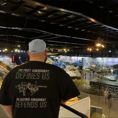 A customer looking at tanks while wearing our Defending Freedom T-shirt.