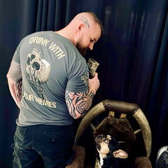 A man and mans best friend wearing our new Drink With Your Enemies T-shirt.