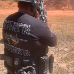 A true warrior at the range while wearing our Defending Freedom T-shirt.