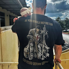 A customer and his baby enjoying their new He Who Kneels Before God T-shirt.