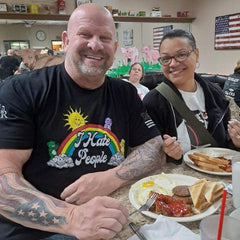 A certified warrior with his wife proudly wearing our quality I Hate People T-Shirt.