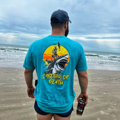 At the beach while wearing our Jaws of Liberty T-Shirt.