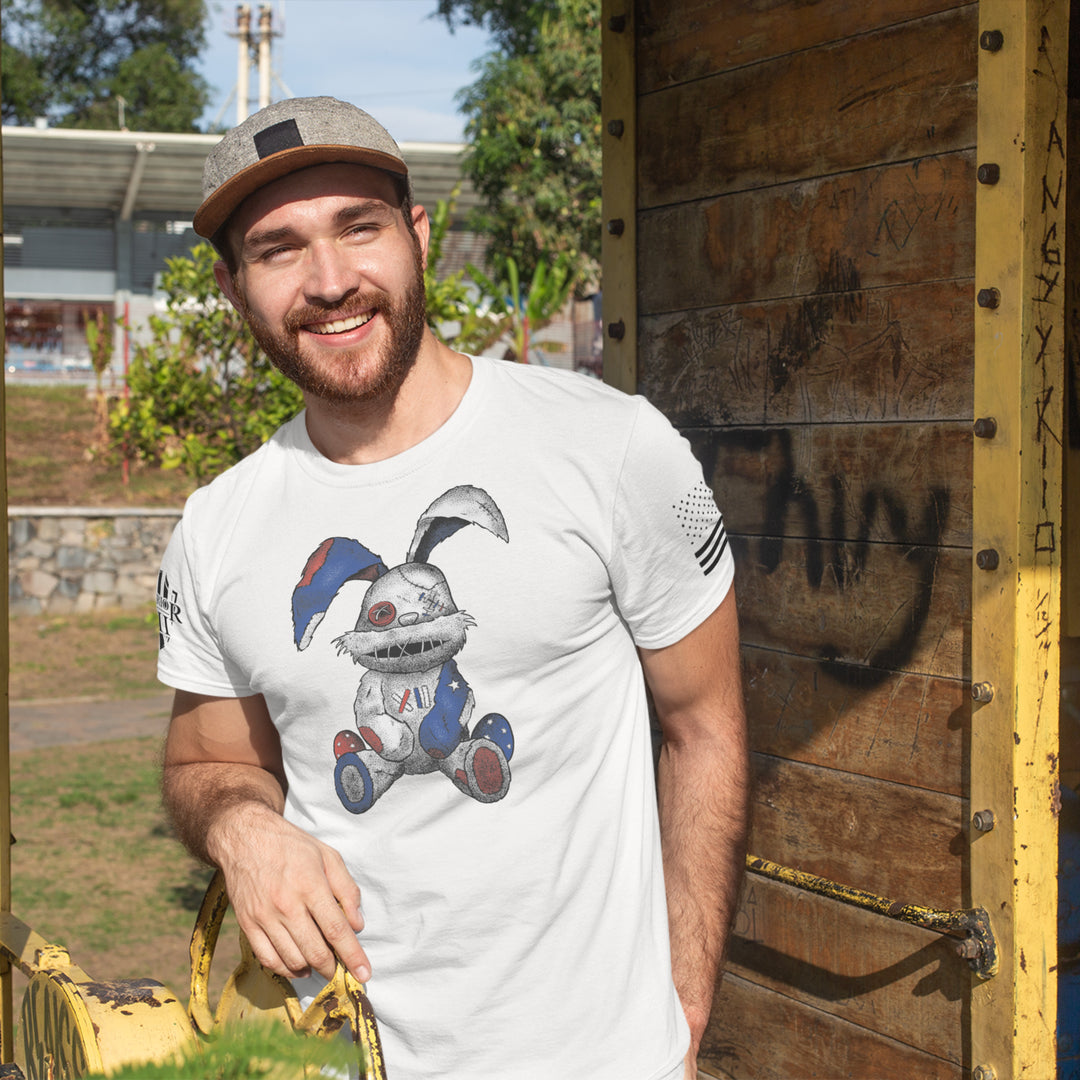 "Stitched Bunny" is printed on a white t-shirt with the main design printed on the front and the back of this t-shirt has no printing. This shirt features our brand logo on the right sleeve and the American Flag on the left sleeve.