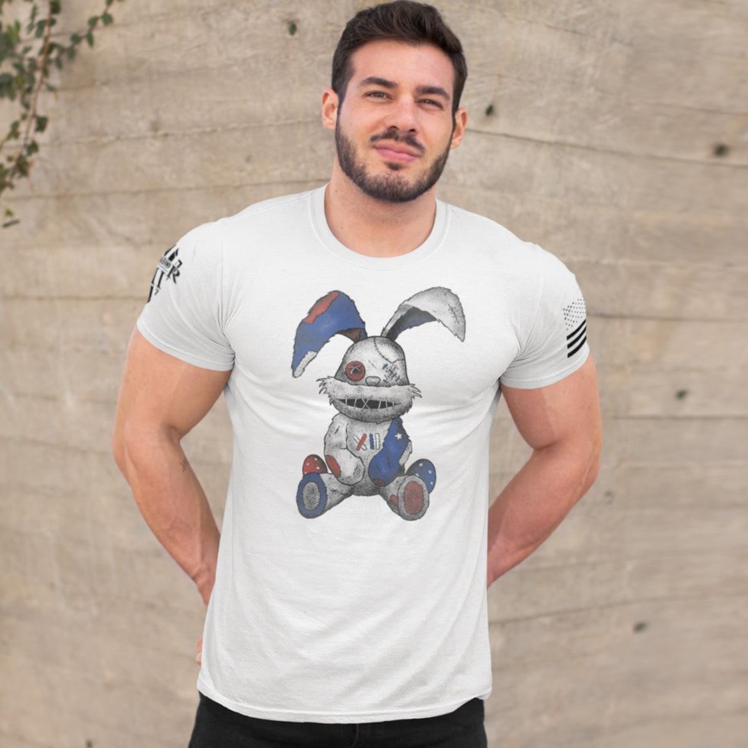 "Stitched Bunny" is printed on a white t-shirt with the main design printed on the front and the back of this t-shirt has no printing. This shirt features our brand logo on the right sleeve and the American Flag on the left sleeve.