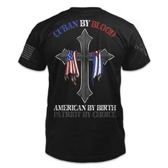 The back of a black t-shirt. The back features a cross with American and Cuban flags draped over it and the words "Cuban by Blood, American By Birth, Patriot by Choice"