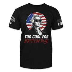 A black t-shirt with an image of George Washington wearing sunglasses in front of an American Flag with the words "Too cool for British rule"