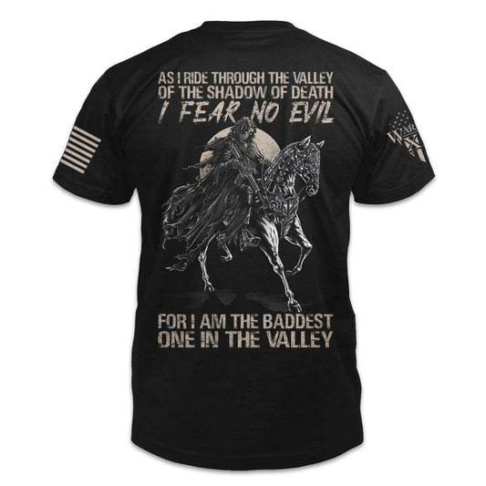The  back of a black t-shirt which has an image of a grim reaper with an AR-15 on a horse with the words "As I ride through the valley of the shadow of death, I fear no evil, for I am the baddest one in the valley."