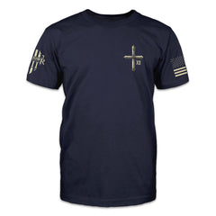 A navy blue t-shirt with a small pocket image on the front of a cross.
