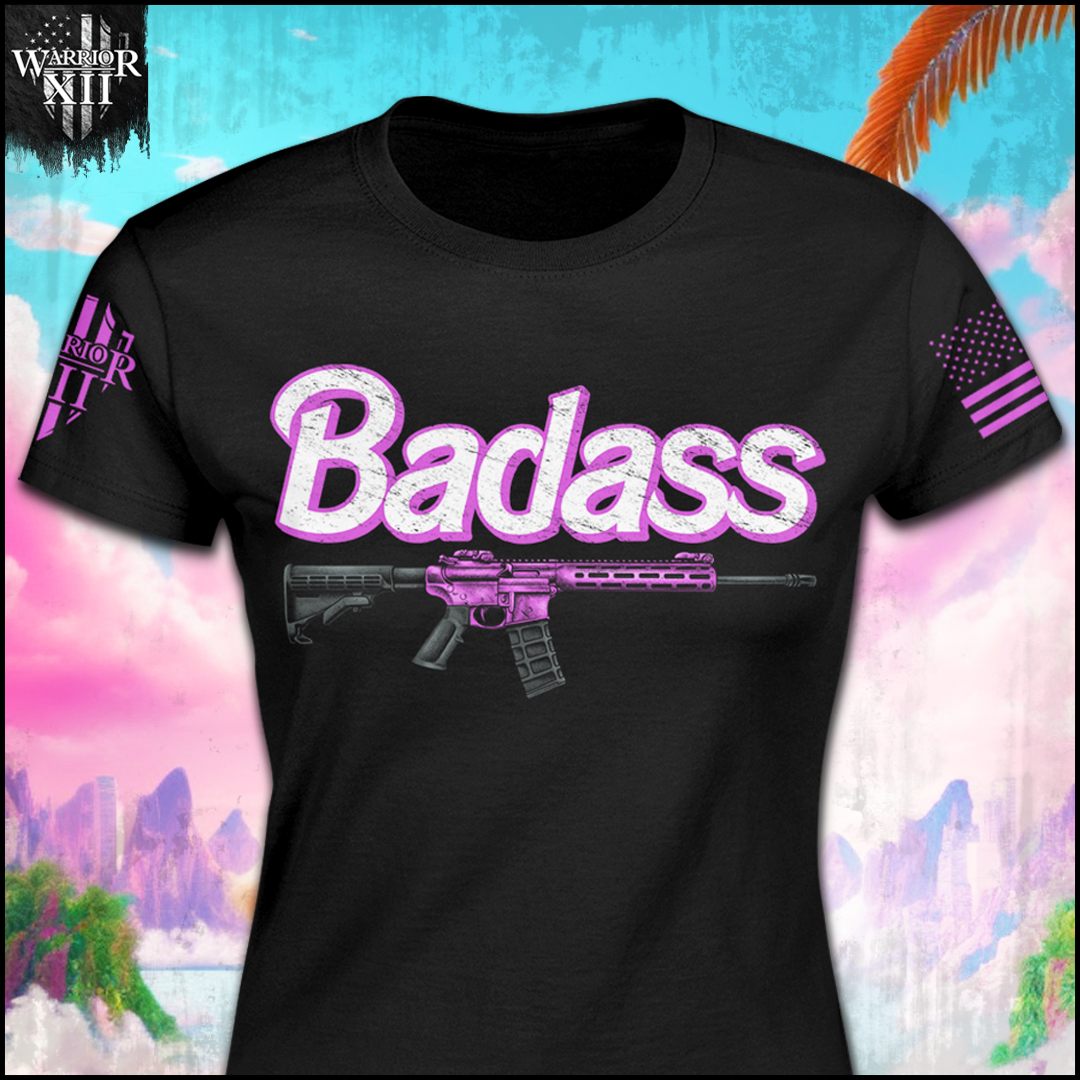 A black women's relaxed fit t-shirt with the word "Badass" in white and hot pink with a black and how pink rifle underneath.
