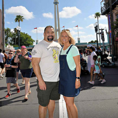 Beautiful couple enjoying a trip to Disney World while representing our Zero Bothers Given t-shirt.