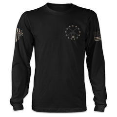 A black long sleeve shirt with a stars and guns graphic on the front.