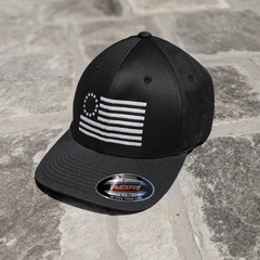 Betsy Ross Flag Flexfit features the Betsy Ross Flag embroidered on a black flexfit hat.