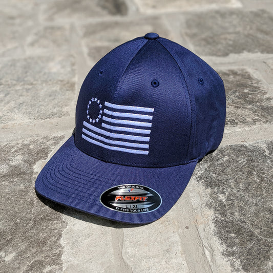 Betsy Ross Flag Flexfit features the Betsy Ross Flag embroidered on a navy blue flexfit hat.