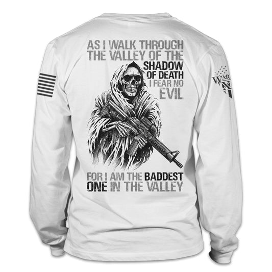 A white Baddest In The Valley long sleeve shirt with the words" As I walk through the valley of the shadow of death, I fear no evil, for I am the baddest one in the valley", printed on the back.