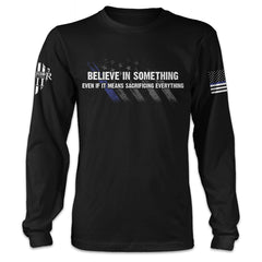 A black long sleeve shirt with the words 'Believe In Something, Even If It Means Sacrificing Everything" printed on the front.