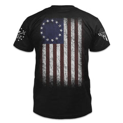 A black t-shirt with the Betsy Ross flag printed on the back.