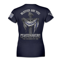 Women's Blessed Are The Peacemakers navy blue t-shirt with the cross, a police hat, and the back the blue flag printed on the back of the shirt.