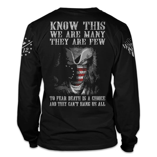 A black long sleeve shirt with the words, "Know This, We Are Many They Are Few. To Fear Death Is A Choice, And They Can't Hang Us All" printed on the back of the shirt.