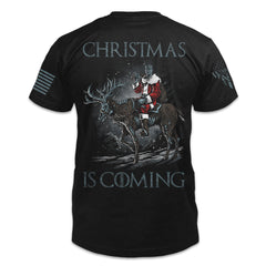 A black t-shirt with the words "Christmas Is Coming" and a horse and figure dressed as Santa Claus.