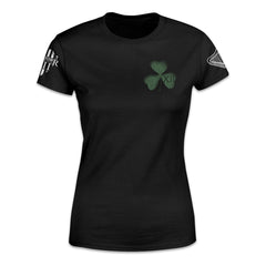 A black women's relaxed shirt with a green clover printed on the front.
