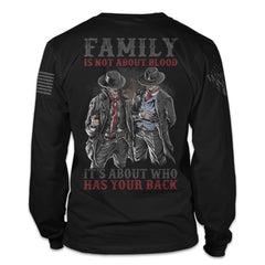 A black long sleeve shirt with the words "Family is not about blood, it's about who has your back" with a two western cowboys printed on the back of the shirt.