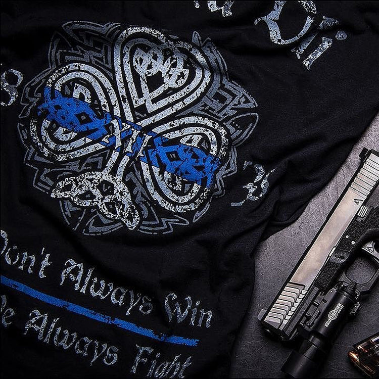 A close up of a  black t-shirt paying tribute to history and traditions of Irish American Law Enforcement and showing true Celtic Pride. Fir Na Dli, meaning, men of law??ç?£ in Gaelic, is written across the back.