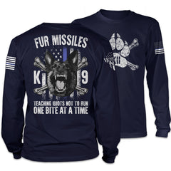 Front & back navy blue long sleeve shirt with the words "Fur Missiles, Teaching Idiots Not To Run, One Bite At A Time!" featuring a german shepherd showing teeth in front of a thin blue line USA flag printed on the shirt.