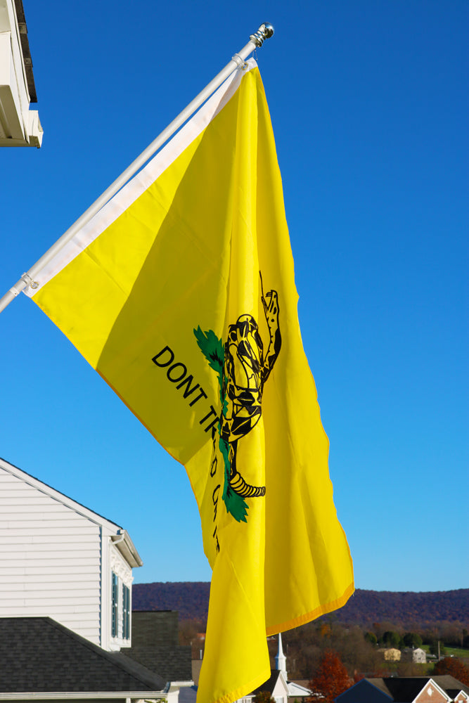 A flag pole holding the Gadsden Don't Tread On Me Flag