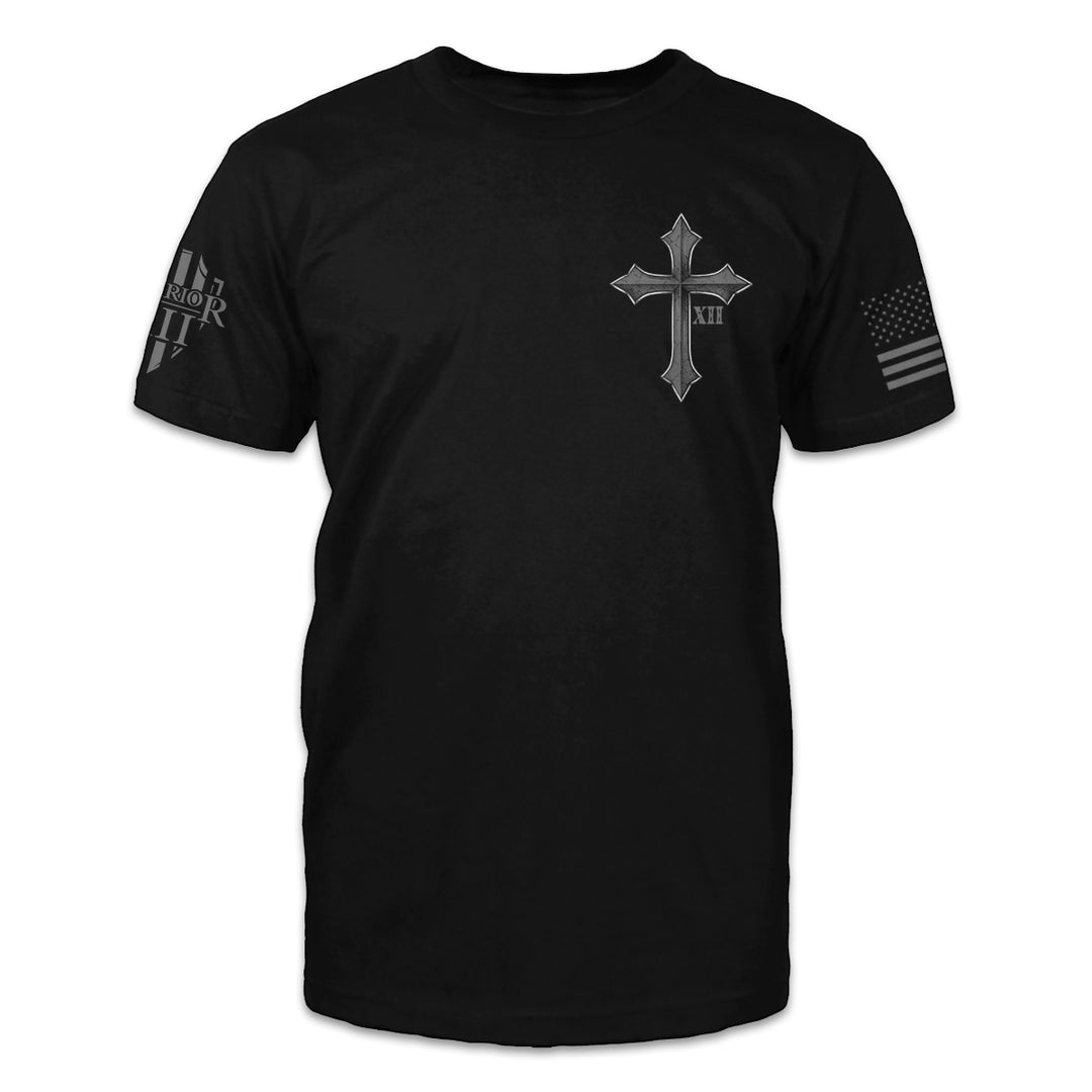 A black t-shirt with a cross and roman numerals XII printed on the front of the shirt.