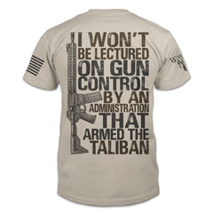 A light tan t-shirt with the words 'I won't be lectured on gun control by an administration that armed the Taliban" with an AR15 printed on the back of the shirt.