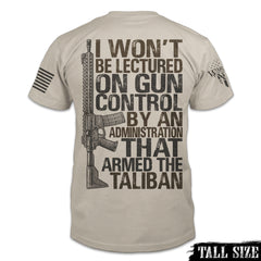 A light tan tall size shirt with the words 'I won't be lectured on gun control by an administration that armed the Taliban" with an AR15 printed on the back of the shirt.
