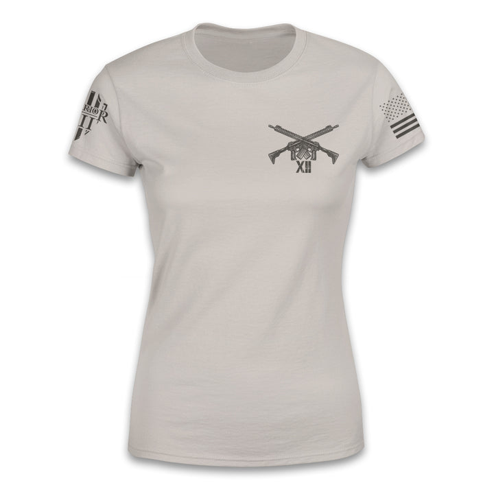 A light tan women relaxed fit'shirt with two guns crossed over printed on the front.