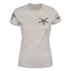 A light tan women relaxed fit shirt with two guns crossed over printed on the front.