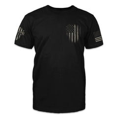A black t-shirt with a darkened USA flag emblem printed on the front.