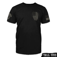 Front  picture of a black tall sized t-shirt with a darkened USA flag emblem printed on the front.