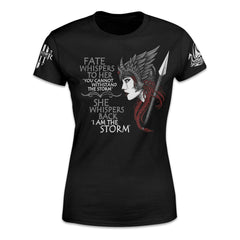 A black women's relaxed fit shirt with the words "Fate whispers to her, "You cannot withstand the storm." She whispers back, "I am the storm" and valkyrie printed on the front of the shirt.