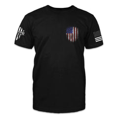The front of a black t shirt showing a small pocket-sized vertical U S flag.