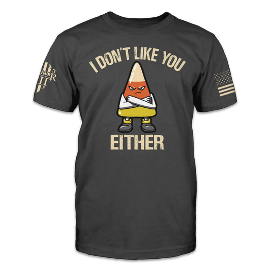 A grey t-shirt with the words" I don't like you either" and an angry cross armed candy corn printed on the front.