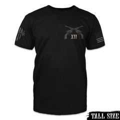 A black tall size shirt with two pistols crossed over with the Roman numerals XII printed on the front of the shirt.