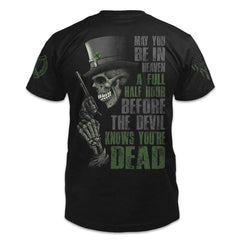 A black t-shirt with the words "May you be in heaven a full half hour before the devil knows you're dead" with a side on view of a skeleton holding a pistol printed on the back of the shirt.