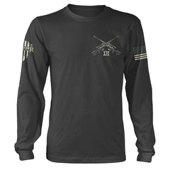 A grey long sleeve shirt with two guns crossed over printed on the front of the shirt.