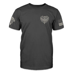The front of a dark grey t-shirt with a small heart made of bullets with the Warrior 12 XII printed on the front pocket area.